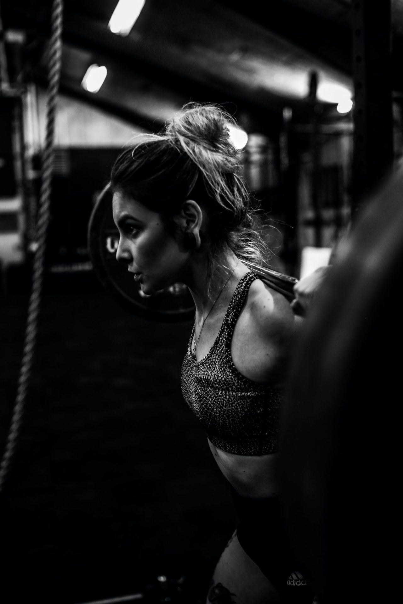 Grayscale image of a woman lifting a barbell at our Birmingham hotel