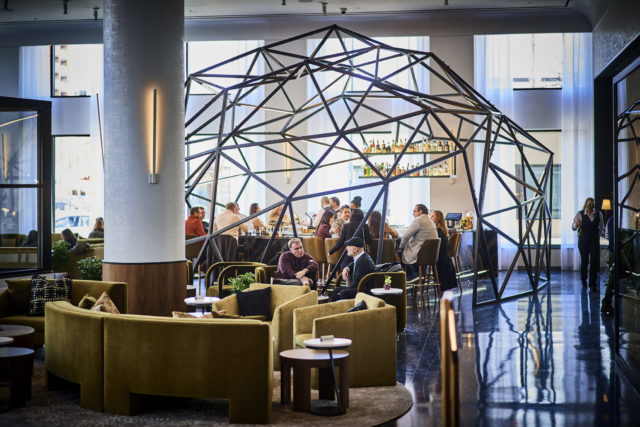 Bar at our luxury hotel in Michigan, sitting under a geometric sculpture