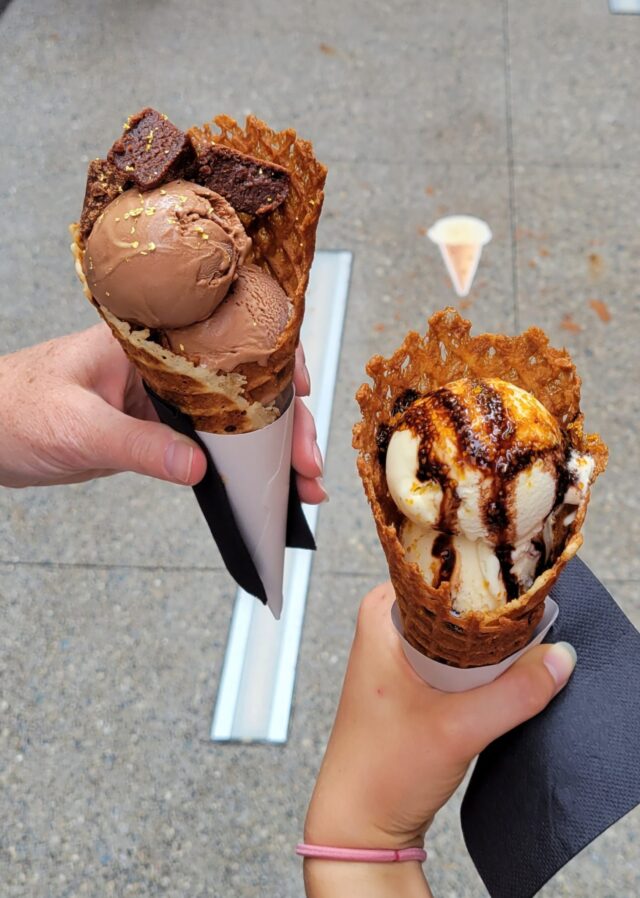 Couple holding chocolate and vanilla ice cream cone near our Birmingham, MI hotel