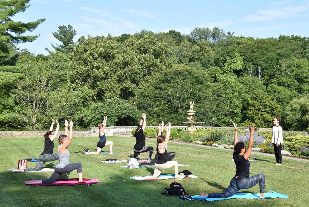 Group of females doing Yoga in the Gardens at Cranbrook House & Gardens near our Birmingham, MI hotel