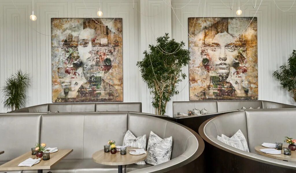 daxton hotel's madam restaurant tables with wall art